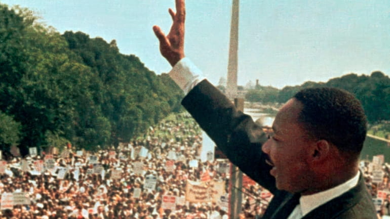 The Rev. Martin Luther King Jr. acknowledges the crowd at...