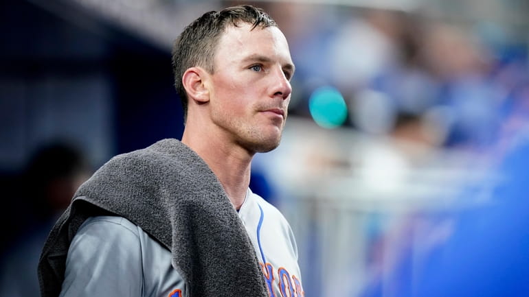 Mets starting pitcher Chris Bassitt looks out from the dugout...