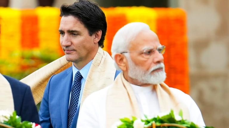 Canada's Prime Minister Justin Trudeau, left, walks past Indian Prime...