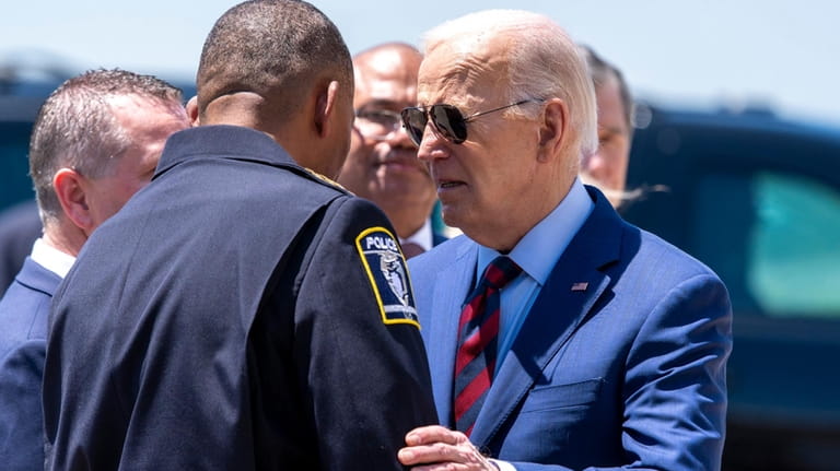 President Joe Biden greets Charlotte-Mecklenburg Police Department Chief Johnny Jennings,...