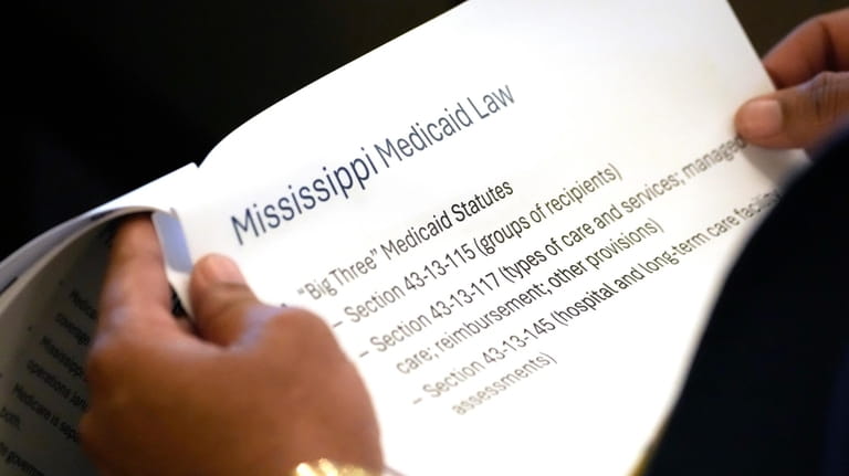 A member of the Mississippi House of Representatives studies an...