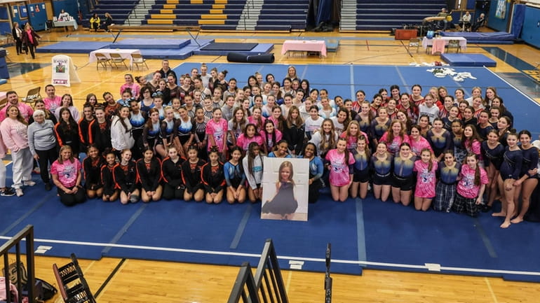 Participants pose before the Cartwheel For A Cure gymnastics meet...