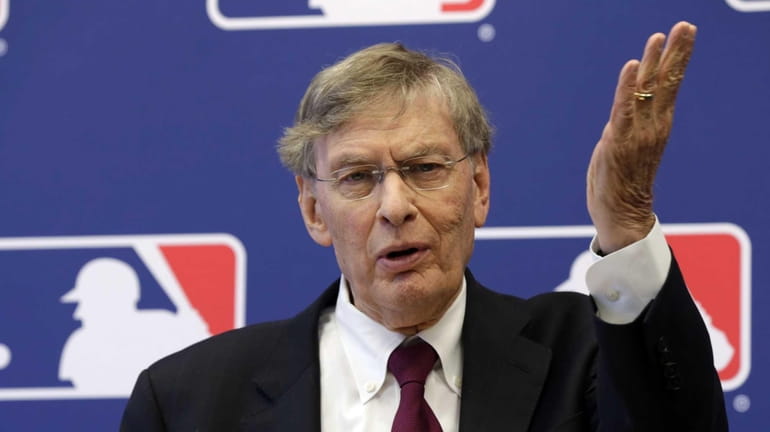MLB commissioner Bud Selig answers a question during a news...