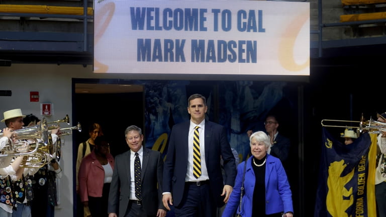 New California men's basketball coach Mark Madsen, center, arrives at...