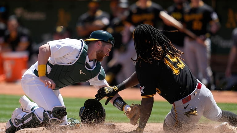 Oakland Athletics catcher Kyle McCann, left, tags out Pittsburgh Pirates'...