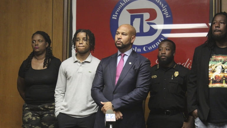 D'Monterrio Gibson, second from left, stands with his attorney Carlos...