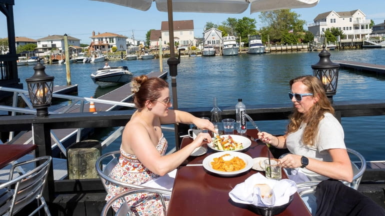 DiAndra Mikelinich, left, and Jessica Sobierajski dine at Catcher's Fish House...