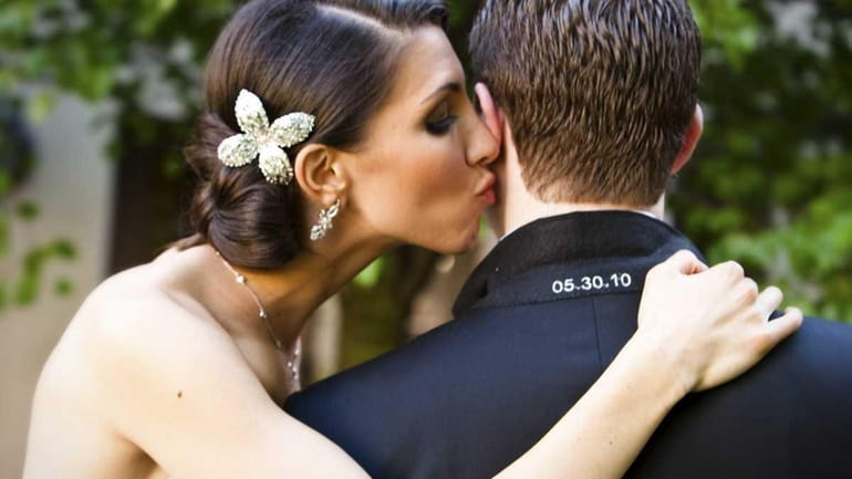 Danielle Kalman gives Ross Zeifman a kiss during their wedding...