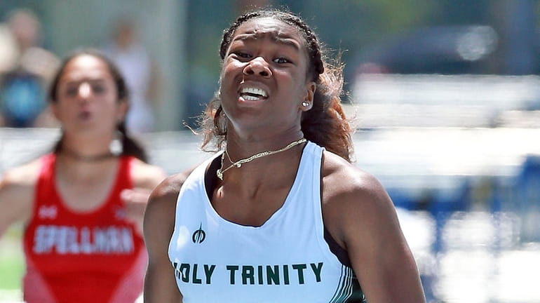 Holy Trinity’s Logan Daley wins the girls 200-meter dash in...