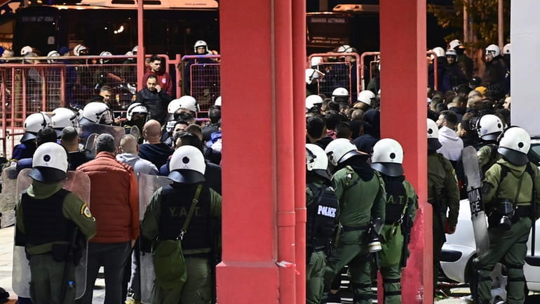 Riot police detain dozens of fans outside the Melina Merkouri...