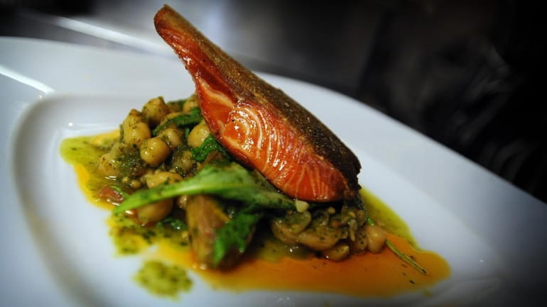 Scottish salmon with braised beans and arugula is served at...