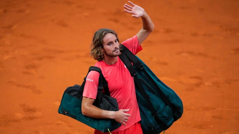 Stefanos Tsitsipas, of Greece, waves to supporters after a match...