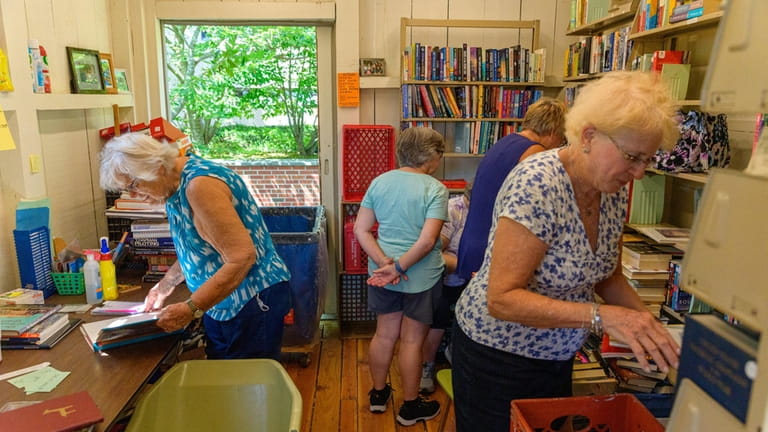Volunteers sort through books at The Yellow Barn.
