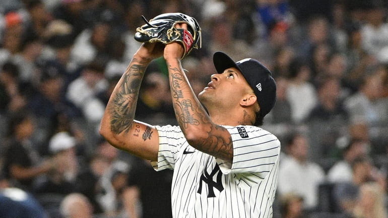 Yankees starting pitcher Luis Gil reacts at the end of...