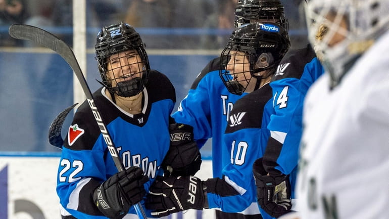 Toronto forward Maggie Connors (22) is congratulated by teammate Alexa...