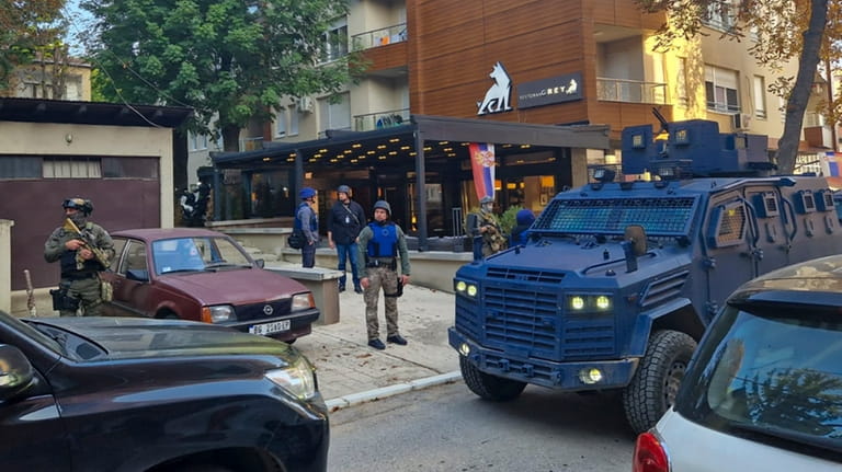 Kosovo police officers search restaurant and building in northern Serb-dominated...