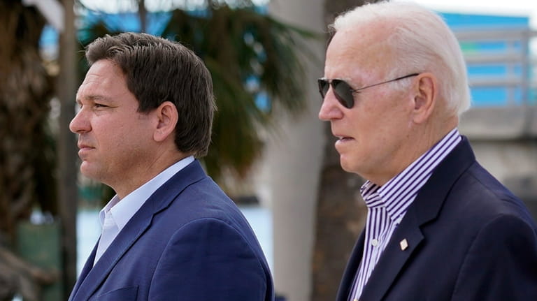 President Joe Biden and Florida Gov. Ron DeSantis arrive to...
