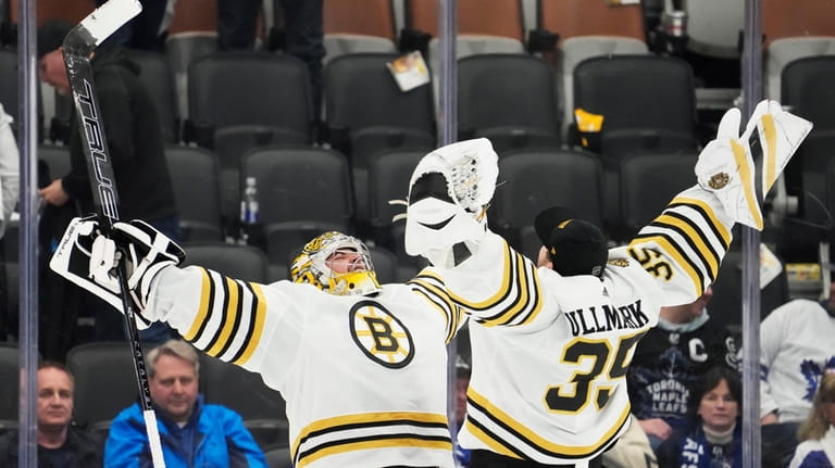 Boston Bruins goaltender Jeremy Swayman, left, and goaltender Linus Ullmark,...