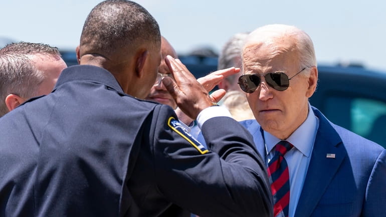 President Joe Biden salutes Charlotte-Mecklenburg Police Department Chief Johnny Jennings,...