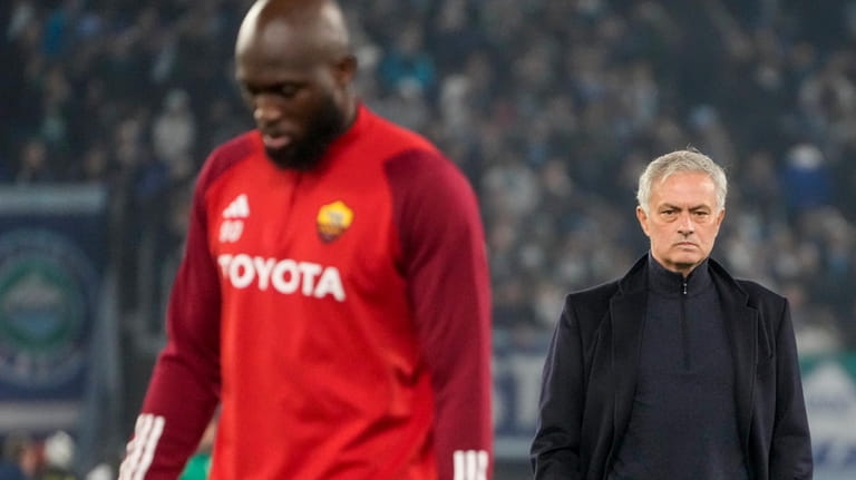 Roma's Romelu Lukaku walks by head coach Jose Mourinho during...