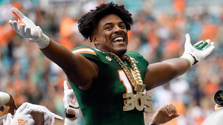 Miami defensive end Gregory Rousseau wears the turnover chain during...