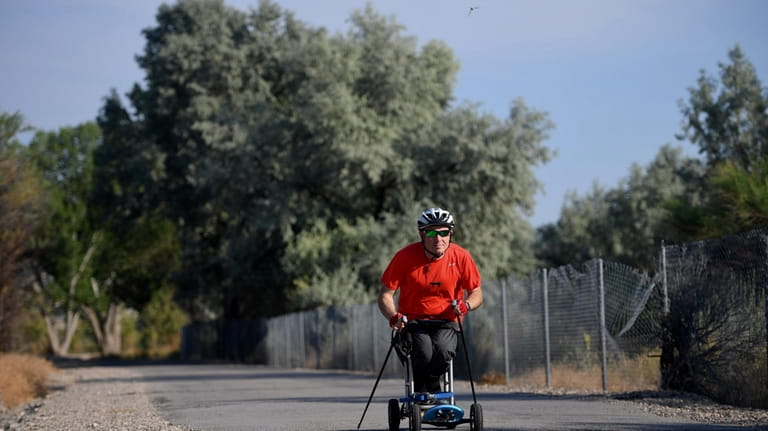 Kevin Hoyt rolls along as he exercises using a paraplegic-friendly...
