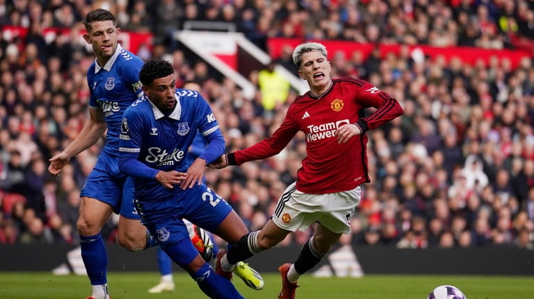 Manchester United's Alejandro Garnacho, right is fouled by Everton's Ben...