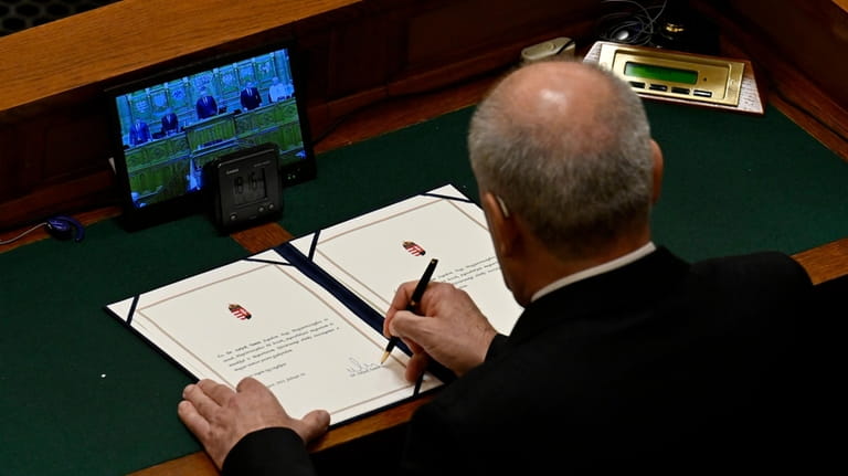 Tamas Sulyok, the former head of Hungary's Constitutional Court, signs...