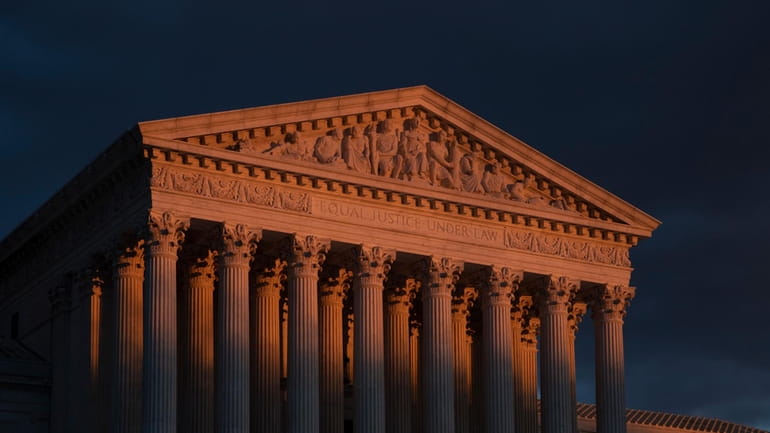 The Supreme Court is seen at sunset in Washington, on...