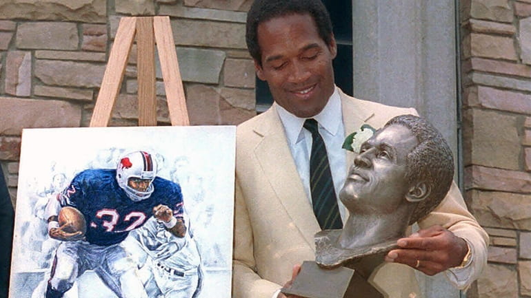 O.J. Simpson checks out the bronze bust of himself after...
