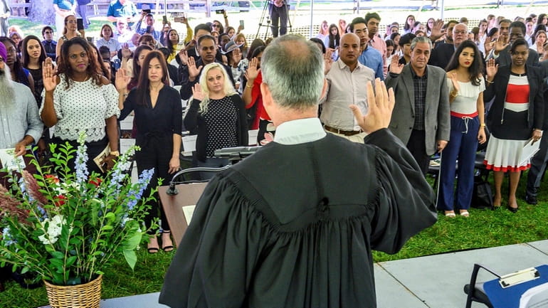 U.S. Second Circuit Judge Joseph Bianco administrates the Oath of Allegiance during a naturalization ceremony...