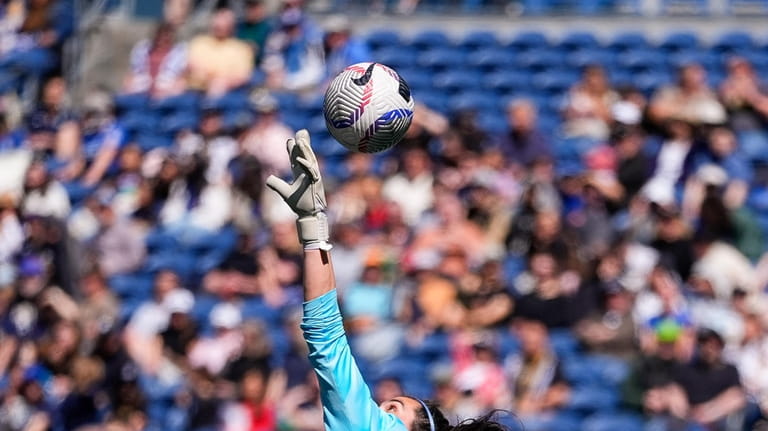Seattle Reign goalkeeper Laurel Ivory tries to tip away a...