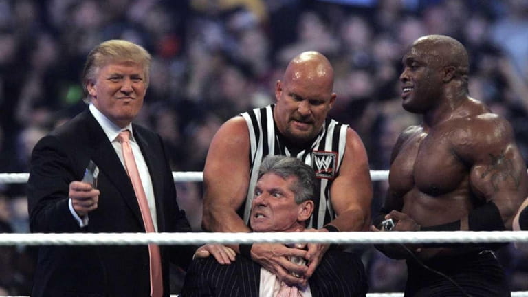 WWE Chairman Vince McMahon, center, held by "Stone Cold" Steve...