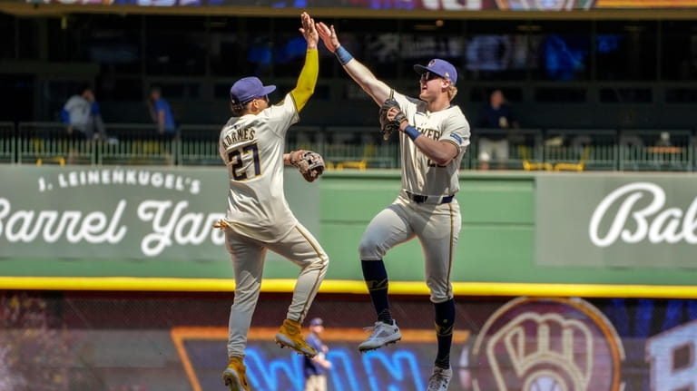 Milwaukee Brewers player Willy Adames and Joey Wiemer celebrate a...