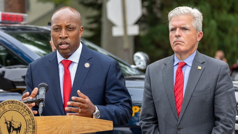Suffolk County Police Commissioner Rodney Harrison, left, and Suffolk County...