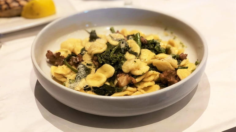 Orecchiette with sausage and broccoli rabe is one of the...