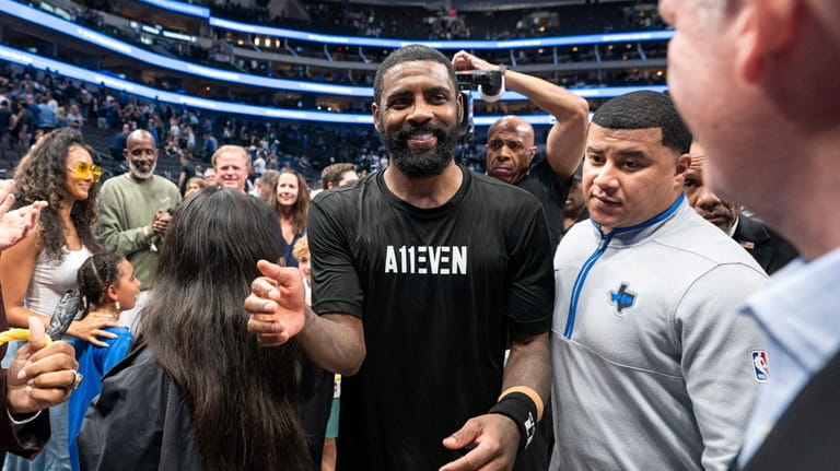 Dallas Mavericks' Kyrie Irving leaves the court after beating the...