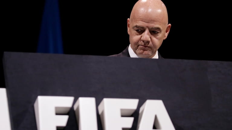 FILE -FIFA President Gianni Infantino walks on the stage before...