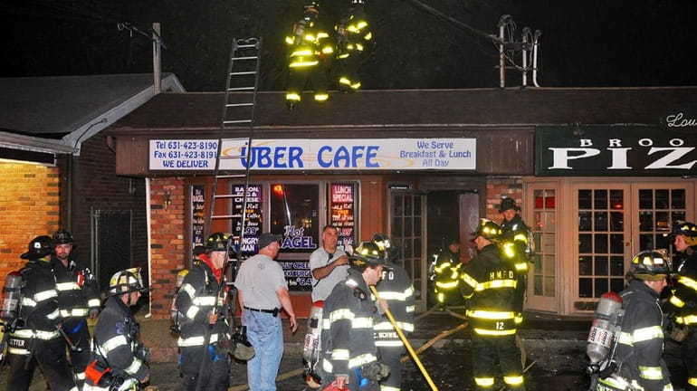 A fire department chaplain collapsed outside a burning bagel cafe...