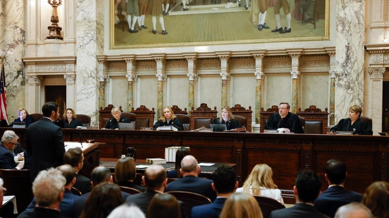 The Wisconsin Supreme Court listens to arguments from Wisconsin Assistant...
