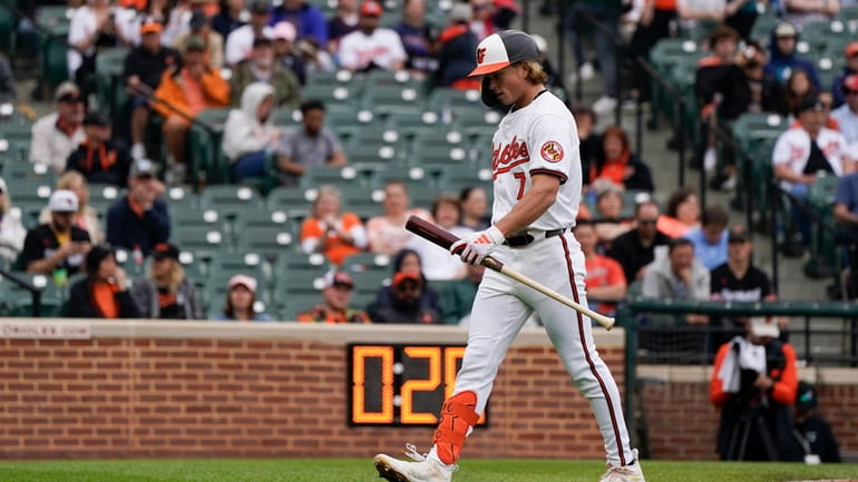 Baltimore Orioles' Jackson Holliday walks to the dugout after striking...
