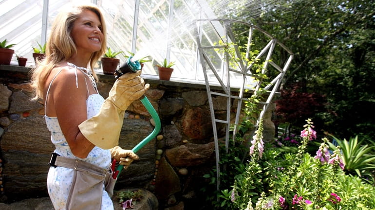 Christie Brinkley works in her garden at her home in...
