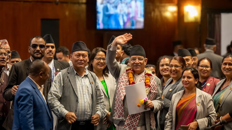 Nepalese Prime Minister Pushpa Kamal Dahal waves to media after...