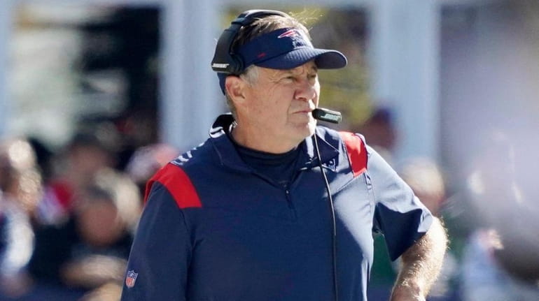 Patriots head coach Bill Belichick walks down the sideline during...