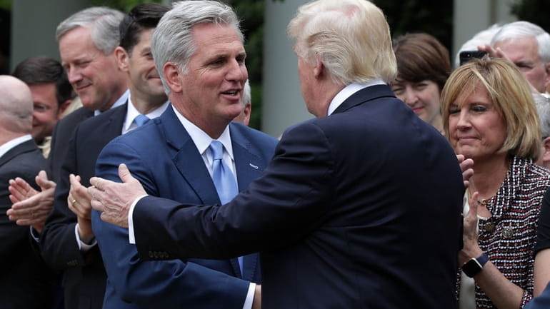Then-President Donald Trump with then-House Majority Leader Kevin McCarthy in...
