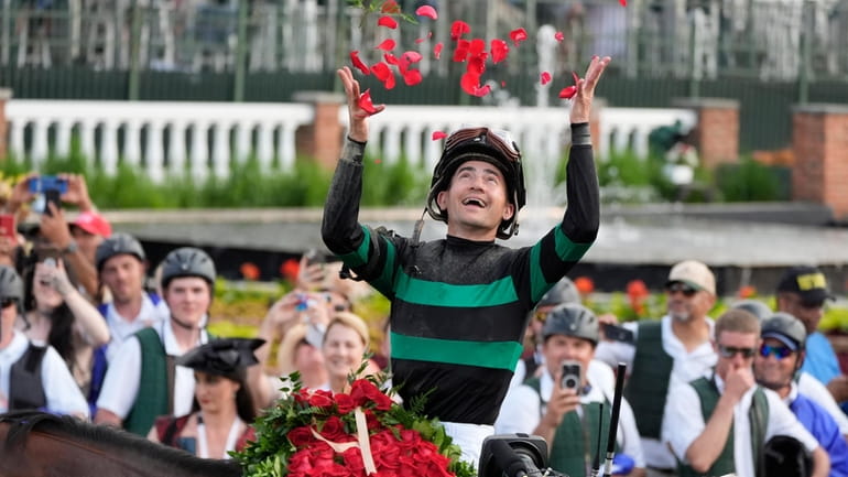 Brian Hernandez Jr. celebrates in the winner's circle after riding...