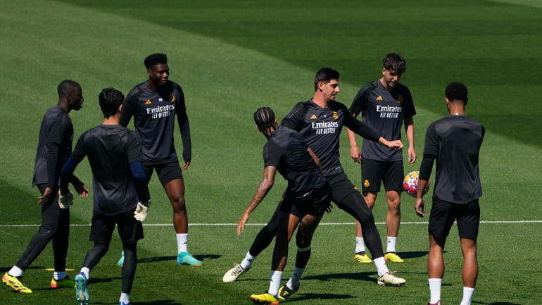 Real Madrid's goalkeeper Thibaut Courtois, third from right, trains with...
