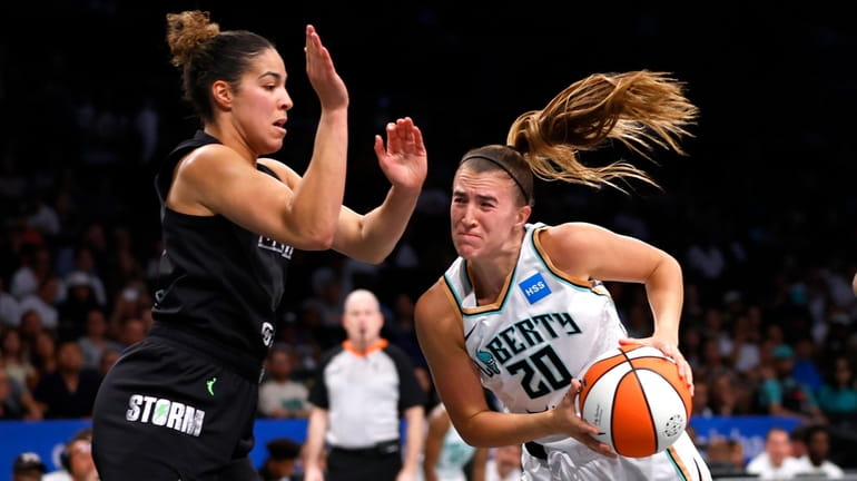 Liberty guard Sabrina Ionescu drives to the basket against Storm...