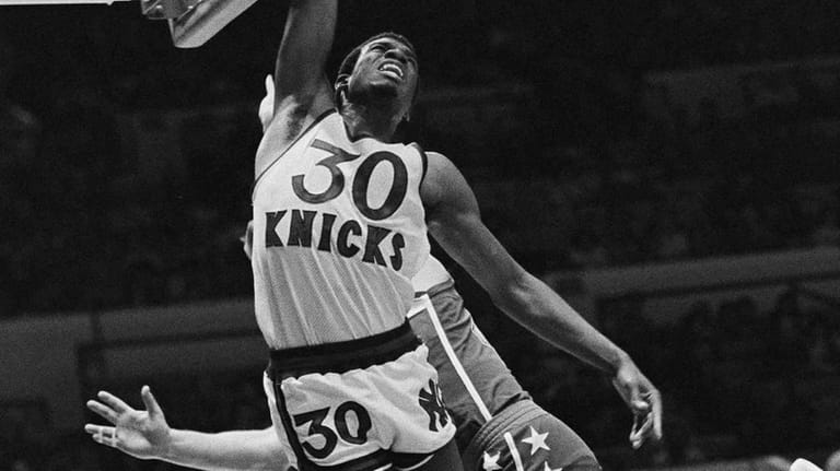 New York Knicks' Bernard King (30) goes up for a shot as his brother New  Jersey Nets' Albert King (55), right, looks on at New York's Madison Square  Garden, Feb. 17, 1984. (