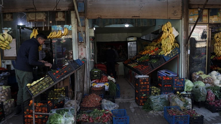 A man buys vegetables in Jinderis, Syria, on Jan. 27,...